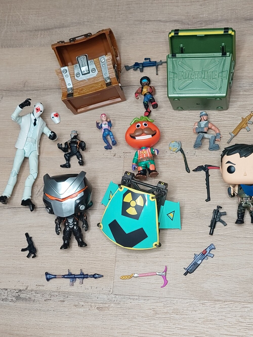 Assorted Fortnite action figures, Funko Pop vinyl figures, and toy accessories.